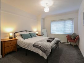 A bedroom with a bed and nightstands at Tan Y Mynydd in Dwygyfylchi