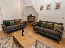 A living room with sofas and a coffee table at Salvin Cottage in Alston