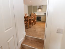 A view of a kitchen with a table and chairs at Salvin Cottage in Alston