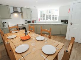A kitchen with a dining table and chairs at Salvin Cottage in Alston