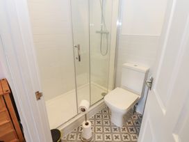 A bathroom with a shower and toilet at Salvin Cottage in Alston