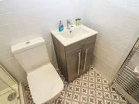 A bathroom with a toilet and sink at Salvin Cottage in Alston