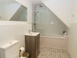 A bathroom with toilet, sink, shower, and bathtub at Salvin Cottage in Alston