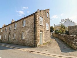 A stone building at the corner of a street at Salvin Cottage in Alston