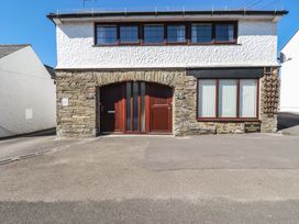 A building with a stone wall, door and windows at The Loft in Truro