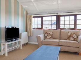 A living room with a television and a sofa at The Loft in Truro