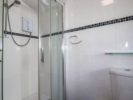 A shower enclosure and toilet in a bathroom at The Loft in Truro