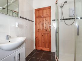 A bathroom with a sink and shower at The Loft in Truro