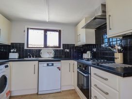 A kitchen with appliances and fixtures at The Loft in Probus