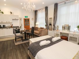 A studio apartment with a kitchen and seating area at The Railway Apartment in Hexham