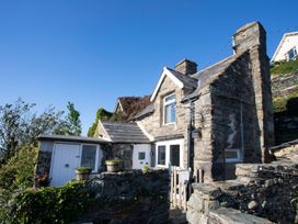 A stone house with a wall and steps at The Ingle in Barmouth