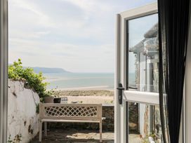 An outdoor area with a bench and a view of the sea at The Ingle in Barmouth