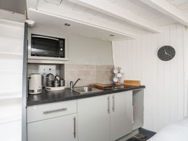A kitchen with a sink and a microwave at The Ingle in Barmouth
