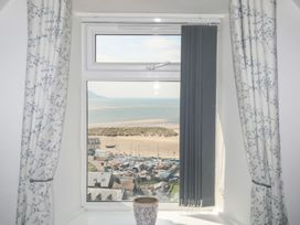 A view from a window showing the sea and boats at The Ingle in Barmouth