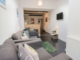 A living room with sofas and a TV at Cloud Cottage in Ambleside