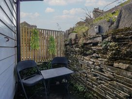 An outdoor seating area with a table and chairs at Cloud Cottage in Ambleside