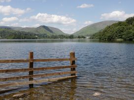 A lake with mountains in the background at Cloud Cottage in Ambleside