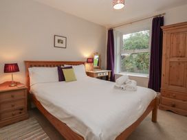 A bedroom with a bed and bedside tables at Cloud Cottage in Ambleside