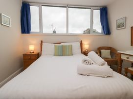 A bedroom with a bed and lamp at Cloud Cottage in Ambleside