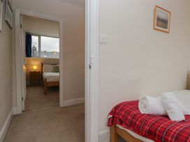 A bedroom with a bed and a window at Cloud Cottage Ambleside