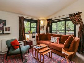 A living room with a sofa and coffee table at Moon Cottage near White Cross Bay Holiday Park near Troutbeck Bridge