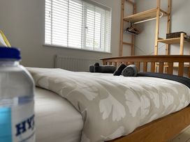 A bedroom with a bed and a shelf at Dolwen in Caernarfon