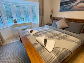 A bedroom with a bed and a desk at Dolwen in Caernarfon