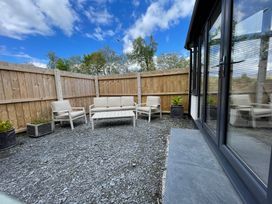 A seating area with a couch and chairs at Dolwen in Caernarfon
