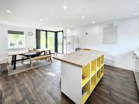 A kitchen with a table and chairs at Hen Stablau in Corwen