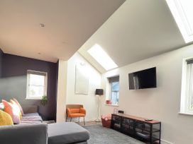 A living room with a sofa and television at Hen Stablau in Dinmael near Cerrigydrudion