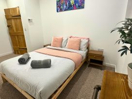A bedroom with a bed, nightstand and towels at Hen Stablau Dinmael near Cerrigydrudion
