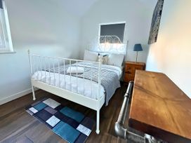 A bedroom with a bed and bedside table at Hen Stablau Dinmael near Cerrigydrudion