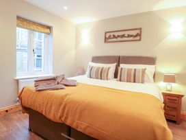 A bedroom with a large bed and a window at The Old Sorting Office 