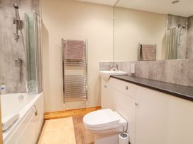 A bathroom with a bathtub and a shower at The Old Sorting Office