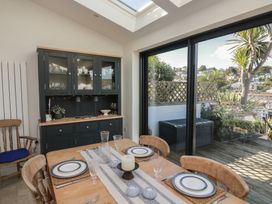 A dining room with a table set for a meal at 36 Crowthers Hill in Dartmouth