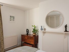 A bedroom with a dresser and mirror at 36 Crowthers Hill in Dartmouth