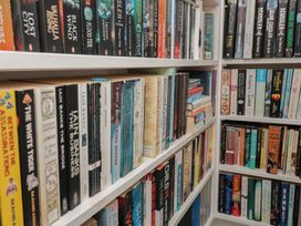 A bookshelf filled with various books at 36 Crowthers Hill in Dartmouth