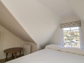 A bedroom with a bed and a table at 36 Crowthers Hill Dartmouth