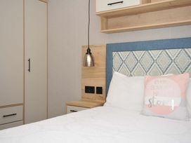 A bedroom with a bed and wardrobe at Eden Way 47
