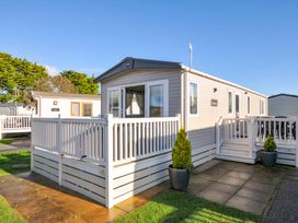 A mobile home with a deck and planter at Eden Way 47 Par