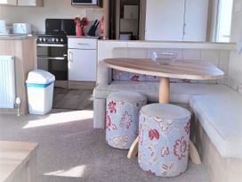 A living room with a sofa and dining table at Par Sands Holiday Park - 6388, Par