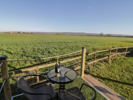 An outdoor space with table and chairs overlooking a field at GiGi's Horsebox Evesham