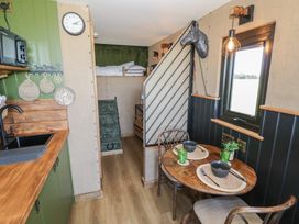 A kitchenette with dining table and chairs at GiGi's Horsebox Evesham