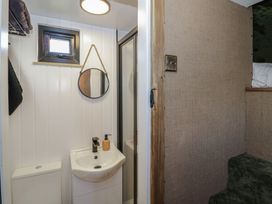 A bathroom with a sink, toilet, and shower at GiGi's Horsebox in Evesham