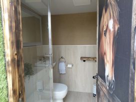 A bathroom with a toilet and sink at GiGi's Horsebox Near Broadway