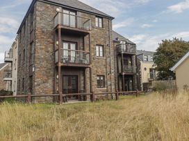 A building with balconies and grass area at Awel y Môr in Burry Port
