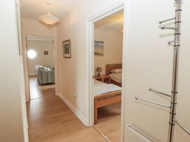 A hallway with a view into a bedroom and living area at Awel y Môr Burry Port