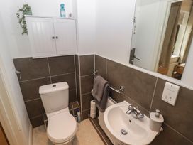 A bathroom with a toilet and sink at Awel y Môr Burry Port
