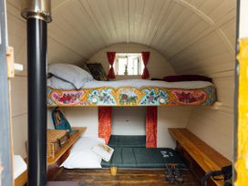 A bedroom with a bunk bed and seating area at Goldfinch Launceston