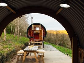 An outdoor area with a dining table and wagon at Goldfinch Launceston